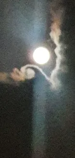 Full moon in a mystical night sky with wispy clouds surrounding it.