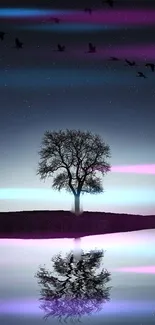 Night wallpaper of a tree with a purple-hued reflective landscape.