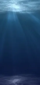 Mystical ocean depths with ethereal beams of light on a mobile wallpaper.