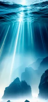 Ocean scene with light rays shining through water onto sea rocks.