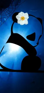 Panda silhouette with flower against cosmic blue background.