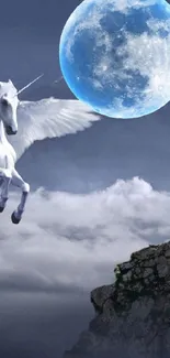 Enchanting pegasus under a mystical blue moonlit sky with clouds and rocks.