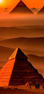 Wallpaper of Egyptian pyramids glowing in a dramatic orange-red sunset.