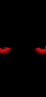 Wallpaper with glowing red eyes on black background.