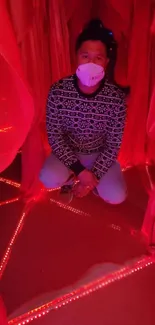 Person in a red-lit artistic room with unique design.