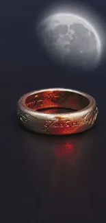 Mystical golden ring with moon in dark setting.