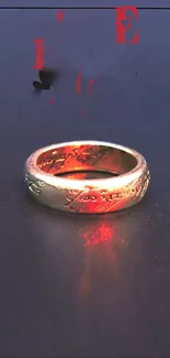 Mystical gold ring with red hues on a dark background.