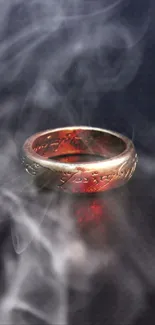 A mystical ring with a fiery red glow and smoky aura on a dark background.