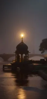 Misty river at night with glowing lamps and tranquil atmosphere.