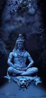 Mystical blue wallpaper with Shiva statue in serene meditation pose.