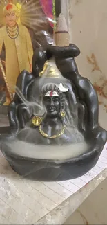 Shiva incense holder with mystical smoke effect and spiritual decor.