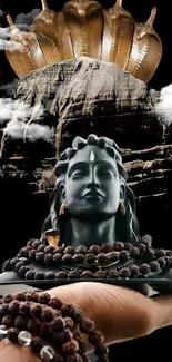 Mystical Shiva statue held in hand, adorned with beads.