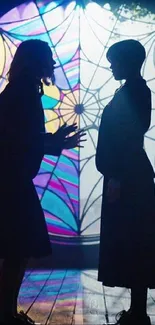 Mystical silhouette of two figures before a stained-glass window.