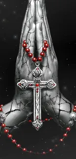 Silver cross with red beads on prayer position hands.