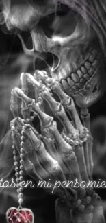 Skeleton praying with rosary and smoke on dark wallpaper.