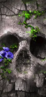 Skull artwork with green moss and a blue flower on cracked texture.