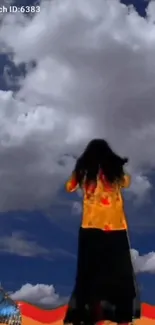 Silhouette of woman under dramatic clouds with vibrant colors and butterfly.