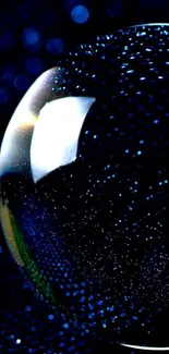 Mystical blue glowing sphere on dark background.