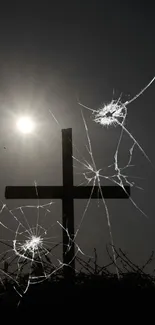 Mystical cross silhouetted by sunlight with dramatic cracked effects.