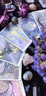 Mystical tarot cards and purple flowers with crystals.