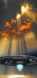 UFO rising with light beams through fiery clouds.