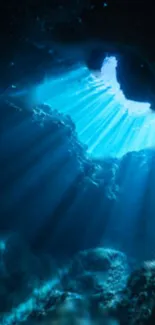 Ethereal blue light illuminates an underwater cave.