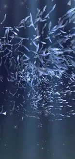 Swarm of fish moving underwater with shimmering blue tones.