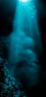 Mystical underwater scene with light rays piercing the ocean depths.