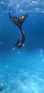 A mermaid diving gracefully underwater with deep blue ocean surroundings.