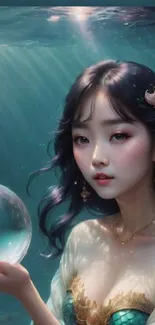 Mystical underwater mermaid holding a glowing orb.