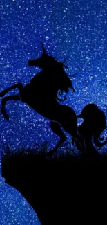 Silhouette of unicorn against a deep blue galaxy starry sky.