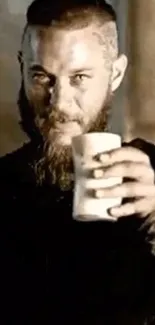 Bearded man holding a chalice with a mystical, medieval vibe.