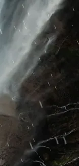 Mystical waterfall cascading over dark rocks.