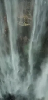 Majestic vertical waterfall cascading down rocky cliff.