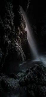 Mystical waterfall cascading in a dark cave setting.