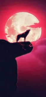 Wolf silhouette on rock under crimson moonlight with a vivid red sky.