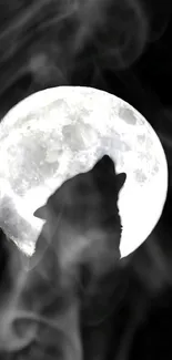 Wolf silhouette on full moon with smoky background.