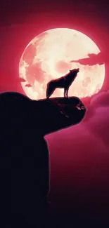 Wolf silhouette on rock with crimson moon in the background.