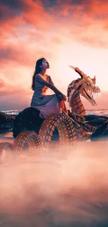 Woman sitting on a dragon at sunset beach with misty, colorful skies.