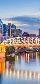 Nashville city skyline at sunset with reflections on river.