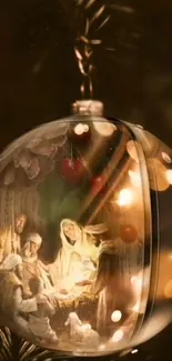 Nativity scene in a Christmas ornament with glowing lights.