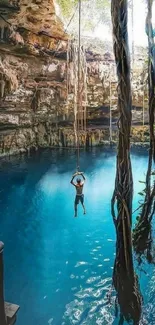 Natural cenote with a swimmer and rope swing, surrounded by azure water.