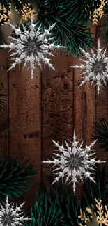 Rustic wood wallpaper with snowflakes and green branches.