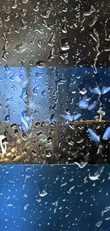 Raindrops on glass with blue flowers and a calming background.