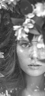 Black and white portrait surrounded by green leaves and white flowers.