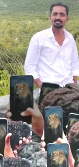 Man in nature surrounded by phones with a lion screen.