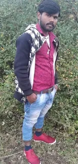 Stylish person in a nature setting, wearing casual attire.