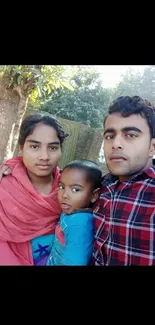 Family in nature with a tree backdrop.