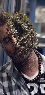 Surreal image of a man's face merging with foliage.