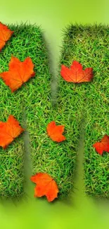 Letter 'M' in grass with orange leaves on green background.